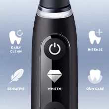 Close-up of a black electric toothbrush handle showing icons and text for brushing modes including DAILY CLEAN, SENSITIVE, INTENSE, GUM CARE, and WHITEN under a diamond icon.