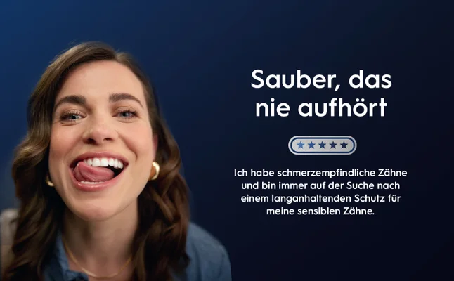 A woman smiles with her tongue touching her lip on a blue background, next to the text Sauber, das nie aufhört, five stars, Ich habe schmerzempfindliche Zähne und bin immer auf der Suche nach einem langanhaltenden Schutz für meine sensiblen Zähne.